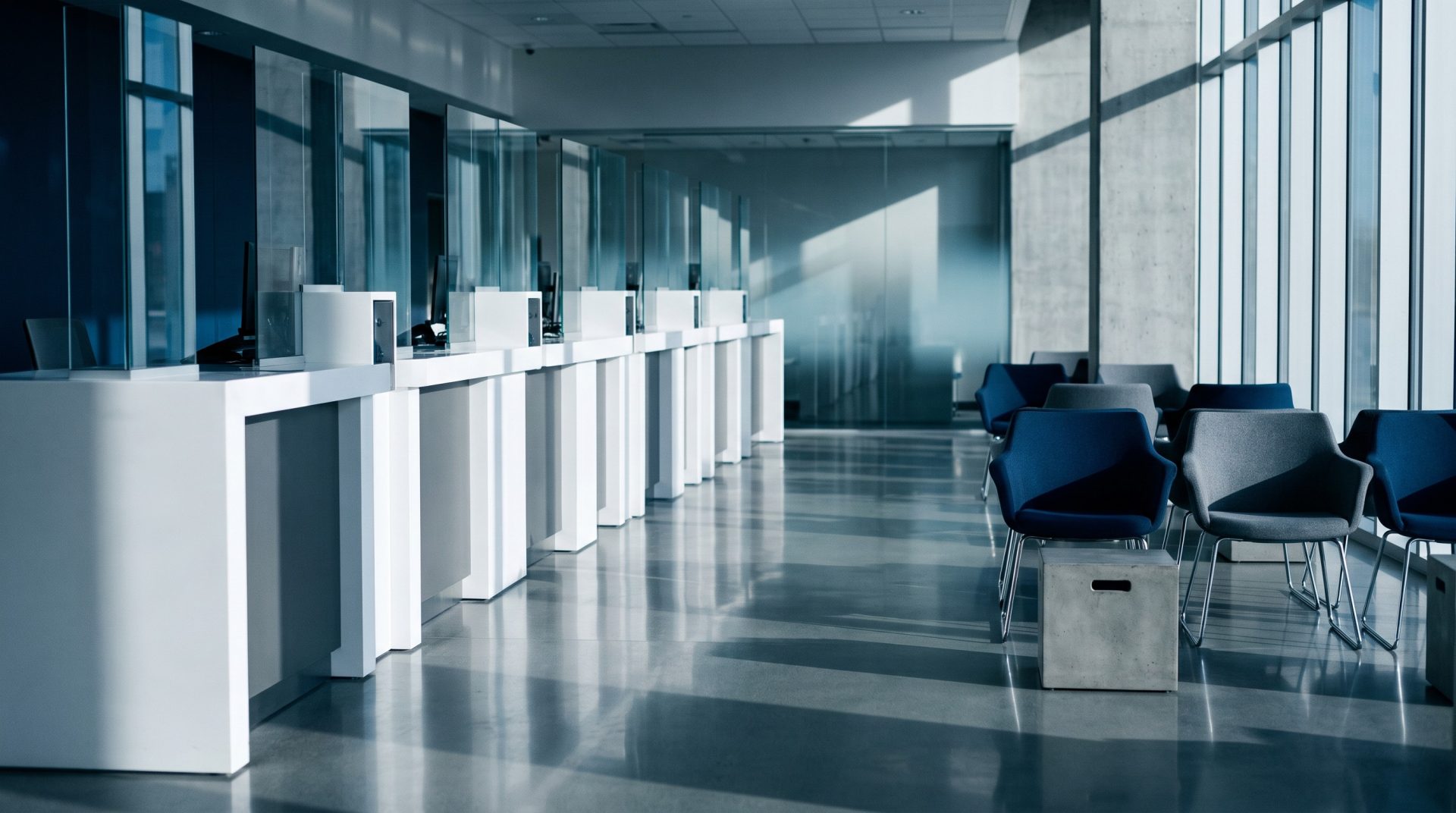 Empty bank branch lobby with teller counters and waiting chairs, cleaned and ready before opening